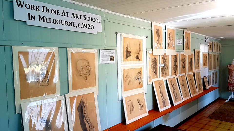 Photograph of collection of pencil drawings completed by Ruby Campbell.  They include technical studies of muscles and body parts, and drawings of classical statues.  Approx 30 drawings are visible in the photograph.