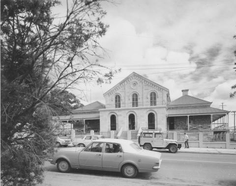View of the the Court House, Ipswich from the road with a car driving in front of the court