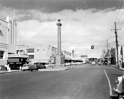 View of a wide street with a large monument in the middle of the road
