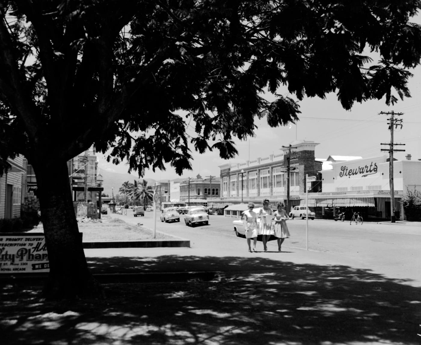 View of Denham Street, Rockhampton featuring cars and buildings