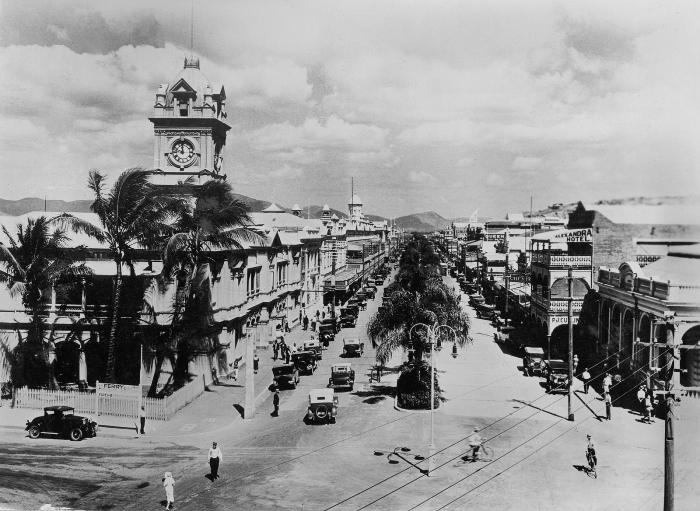 View of Townsville's Flinders Street with hundreds gathered for a street procession in the early 1930s