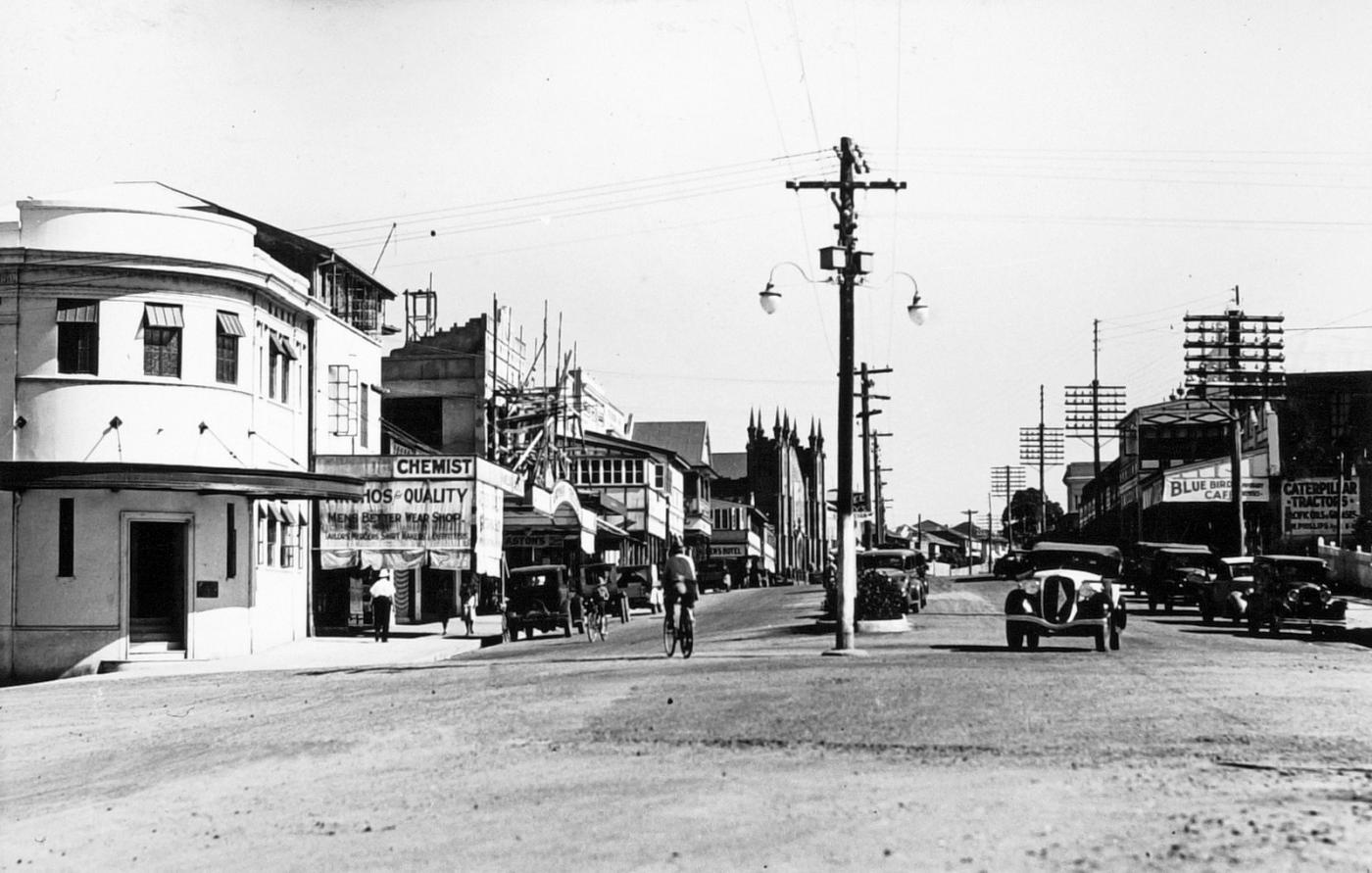 View of a Rankin Street, showing some older style cars, buildings and telegraph poles
