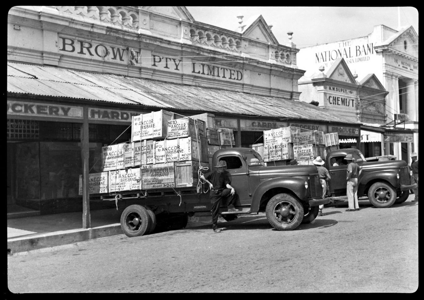 A old-style Ford truck laden with boxes making a delivery