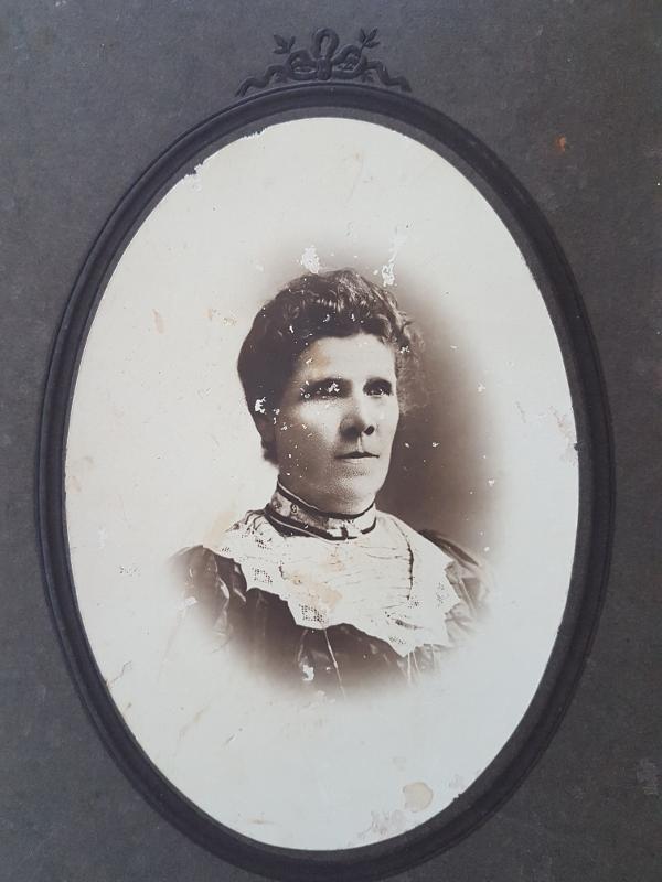 Black and white photograph of Elizabeth Campbell (nee Brydges). In this image Elizabeth is middle aged, and wears a dark dress with wide lace collar, and a small brooch at the neckline.