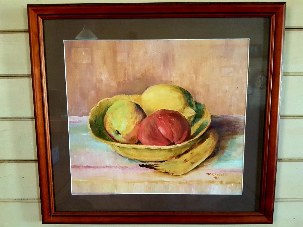 Acrylic still life of a fruit bowl by Ruby Campbell.  The yellow bowl contains a lemon, an apple and what appears to be a tomato, but may be a different kind of fruit!  A banana lies on the table beside the bowl.  The signature RM CAMPBELL 1961 is at lower right of image.