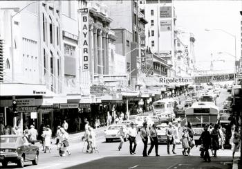 People crossing the road on a busy Queen Street