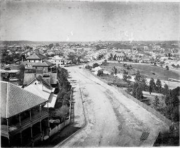 Sweeping view of Wickham Terrace showing a dirt road and numerous wooden houses