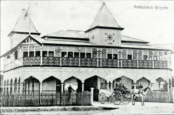 Exterior of an ornate building with verandahs and attic peaks
